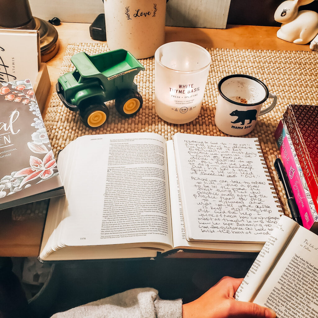 Bible, journal, and candle indoors. 